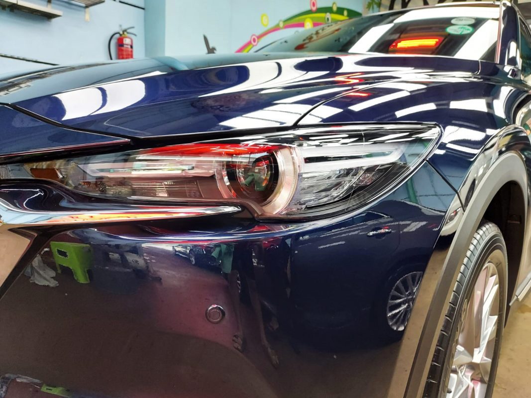 The CX-8's coated paintwork showing clean reflections.