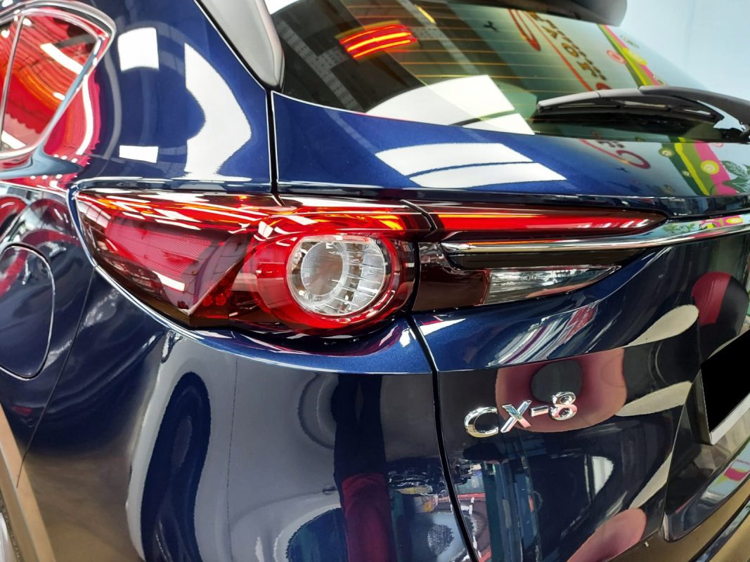 The coated bonnet of the Mazda CX-8 under workshop lighting.