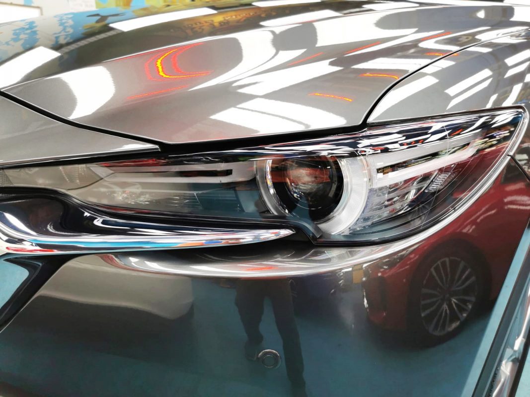 The CX-8's coated paintwork showing clean reflections.