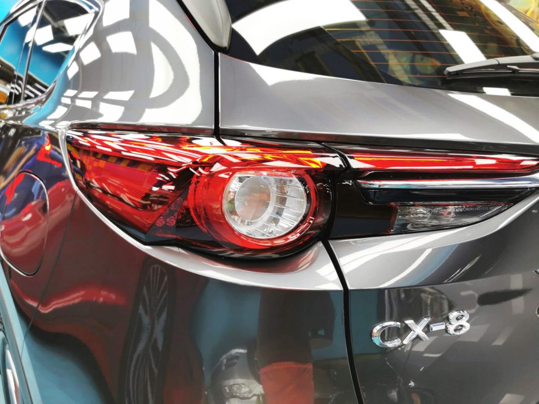The coated bonnet of the Mazda CX-8 under workshop lighting.