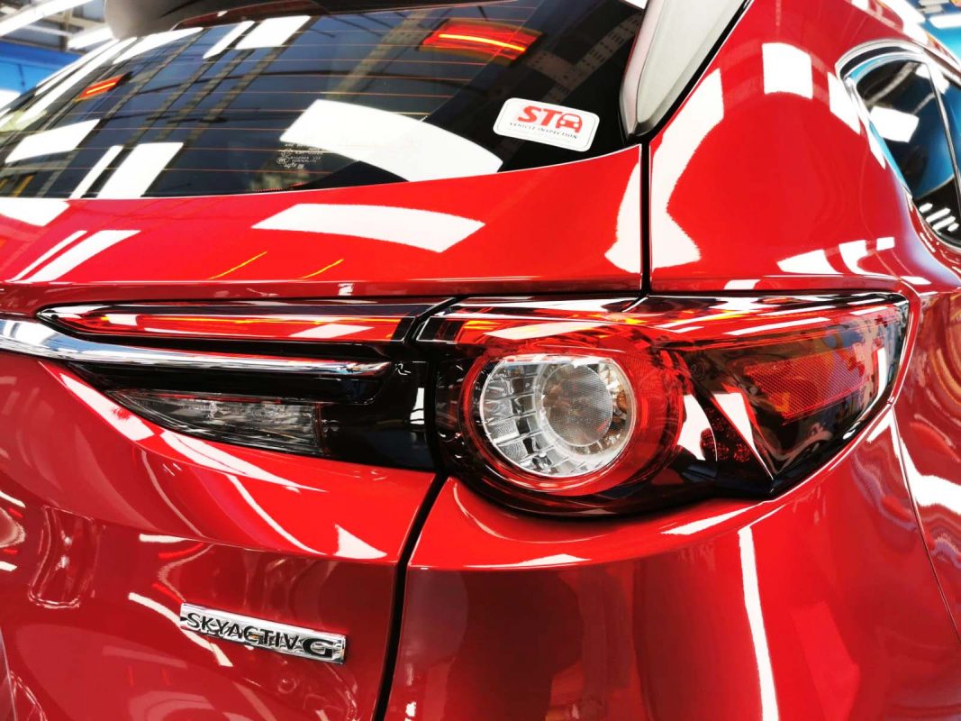 The coated bonnet of the CX-8 under workshop lighting.