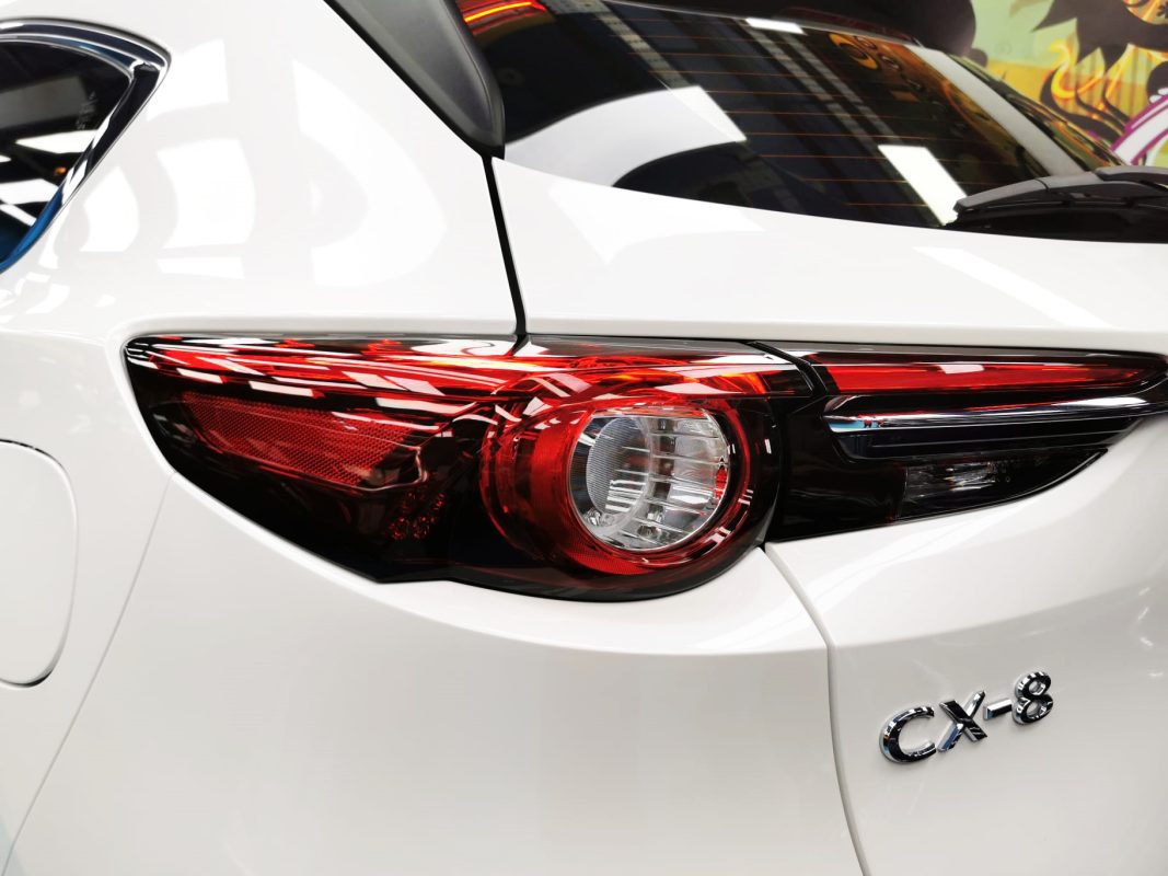 The coated bonnet of the Mazda CX-8 under workshop lighting.