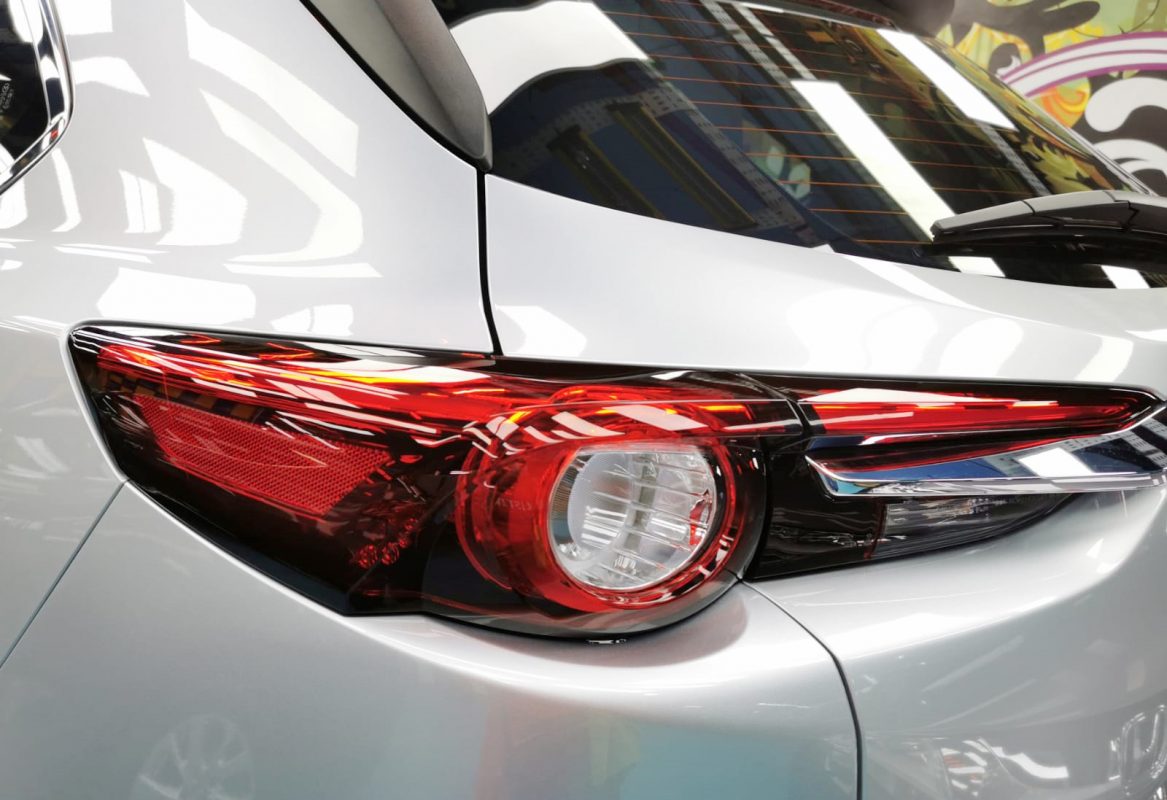 The coated bonnet of the Mazda CX-9 under workshop lighting.