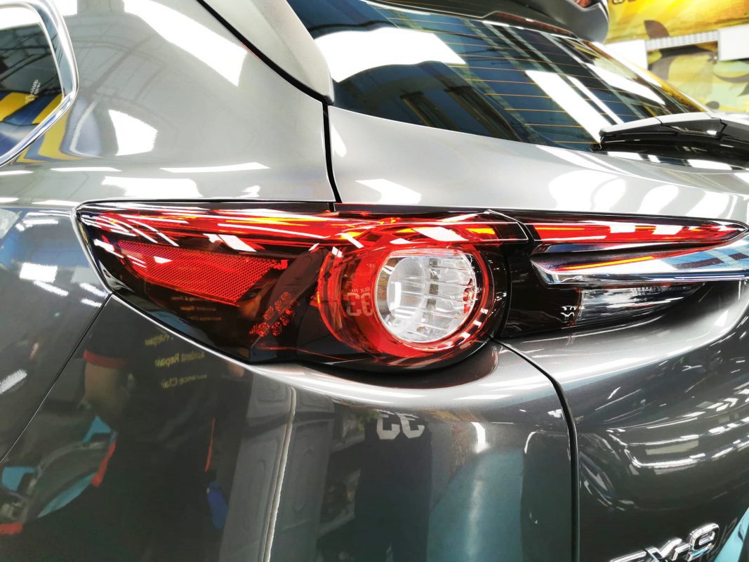 The coated bonnet of the Mazda CX-9 under workshop lighting.