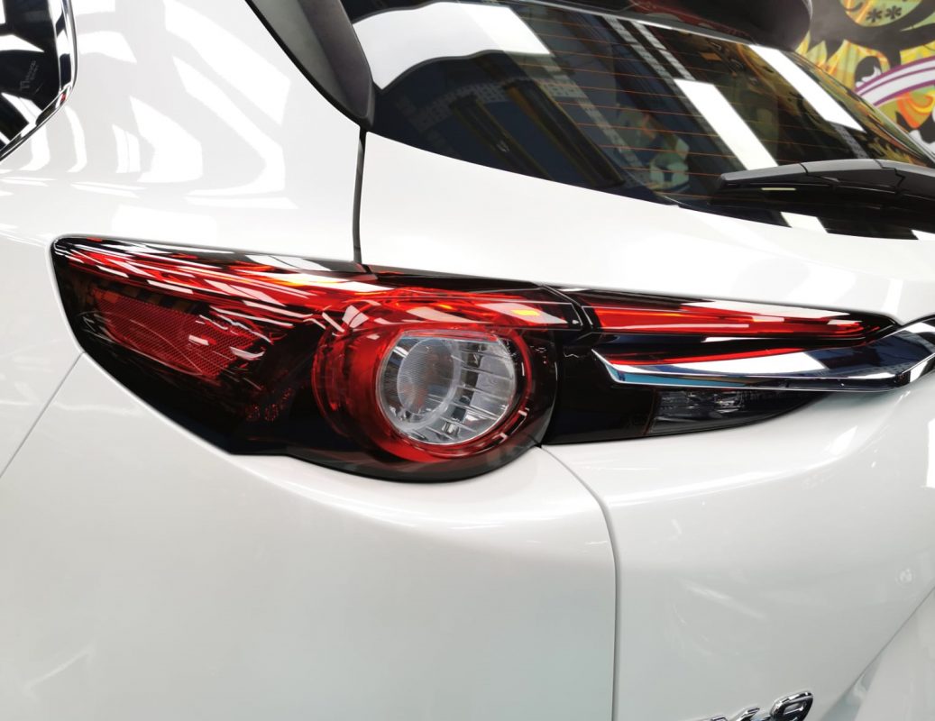 The coated bonnet of the Mazda CX-9 under workshop lighting.