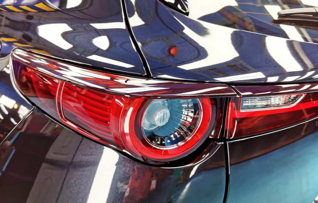 The coated bonnet of the Mazda CX-3 under workshop lighting.