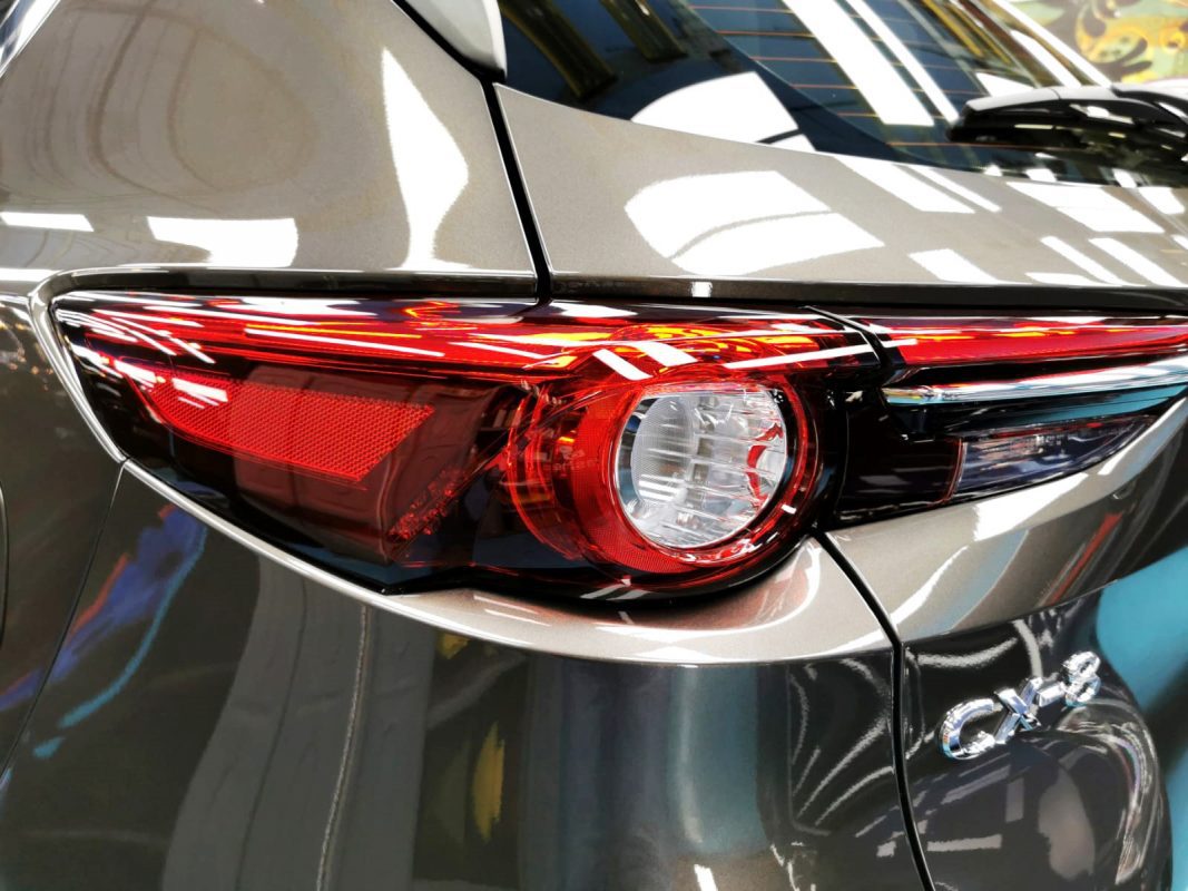 The coated bonnet of the Mazda CX-8 under workshop lighting.