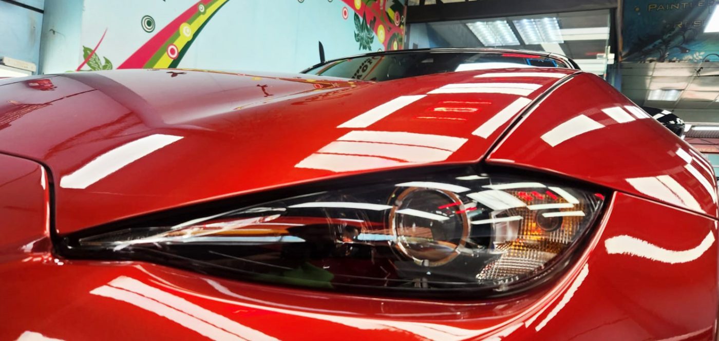 The MX-5's coated paintwork showing clean reflections.