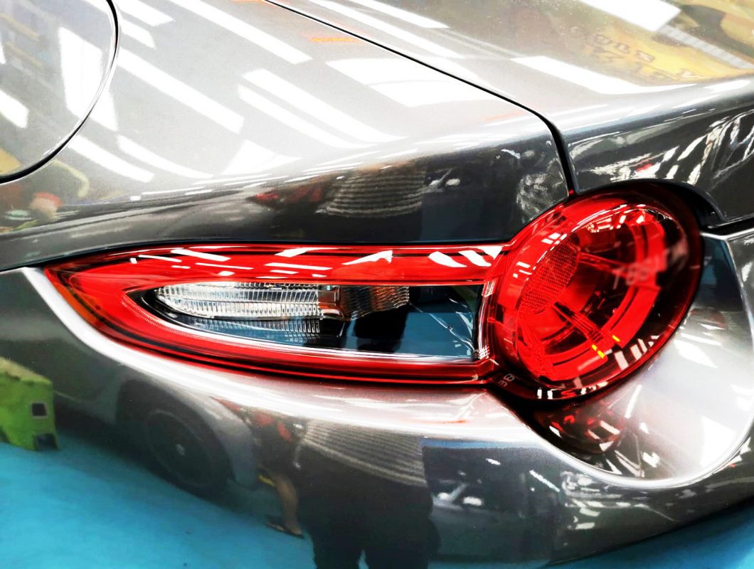 The coated bonnet of the MX-5 under workshop lighting.