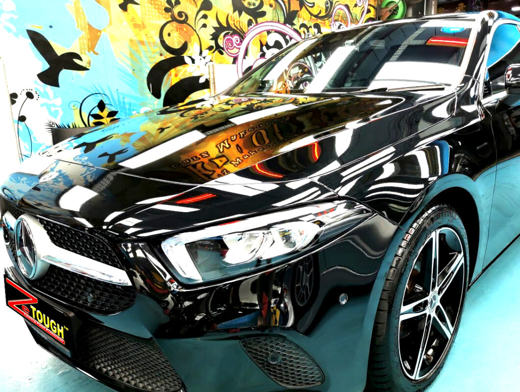 The Mercedes-Benz A180's coated paintwork under workshop lighting.