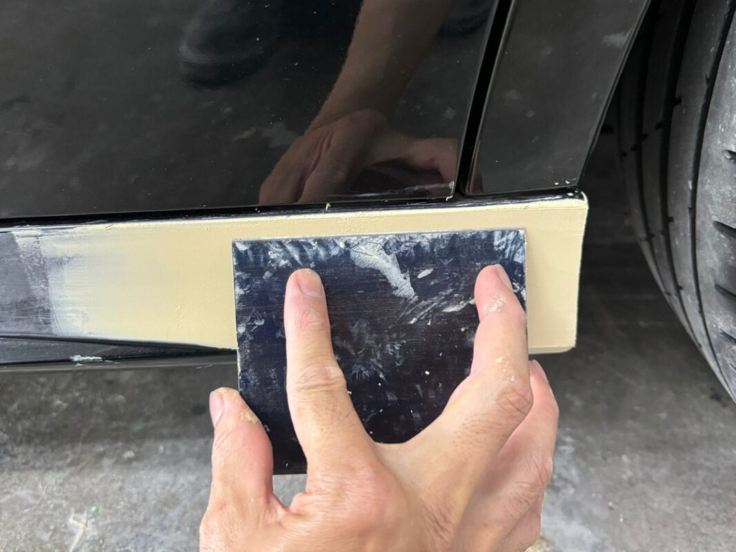 Surface of the A180 patched and smoothed, filler applied to damaged areas.