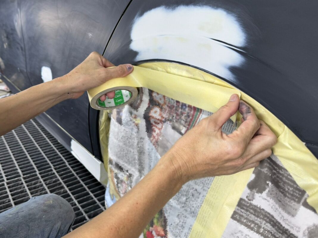 Masking the Mercedes-Benz A180 before entering the spray booth.