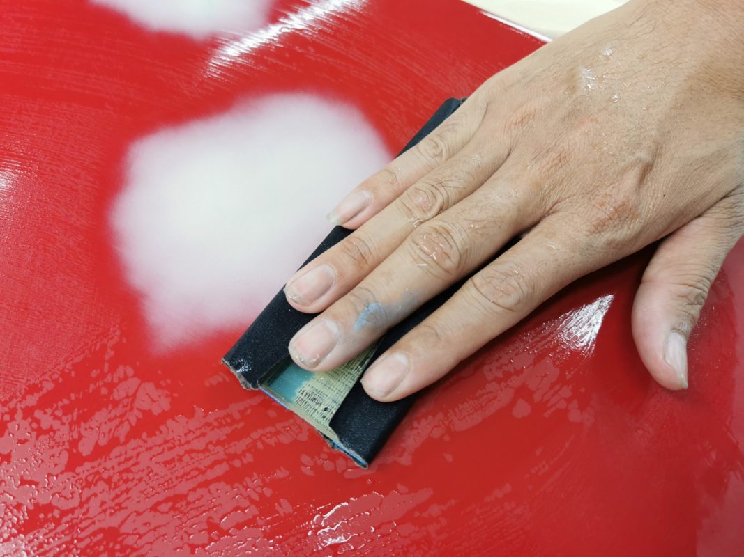 Close-up of sanding work on a panel of the Mercedes-Benz A180.