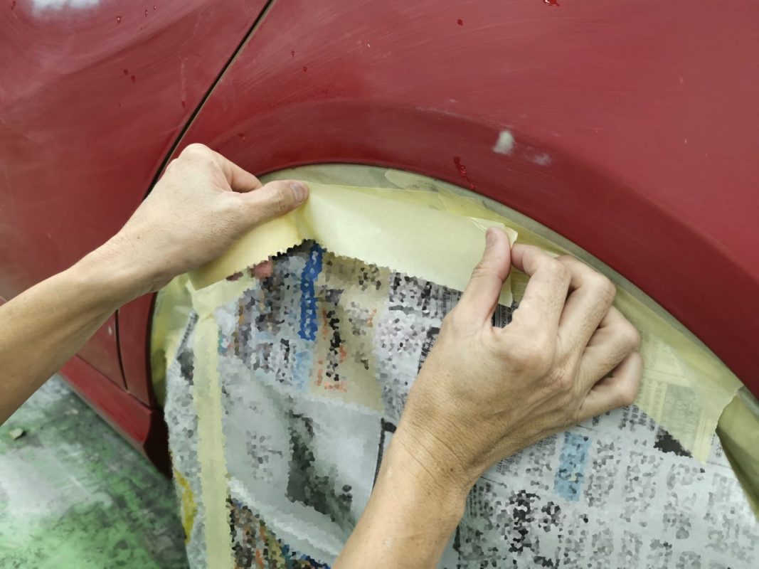 The Mercedes-Benz A180 in the spray booth with the fresh coat being applied.