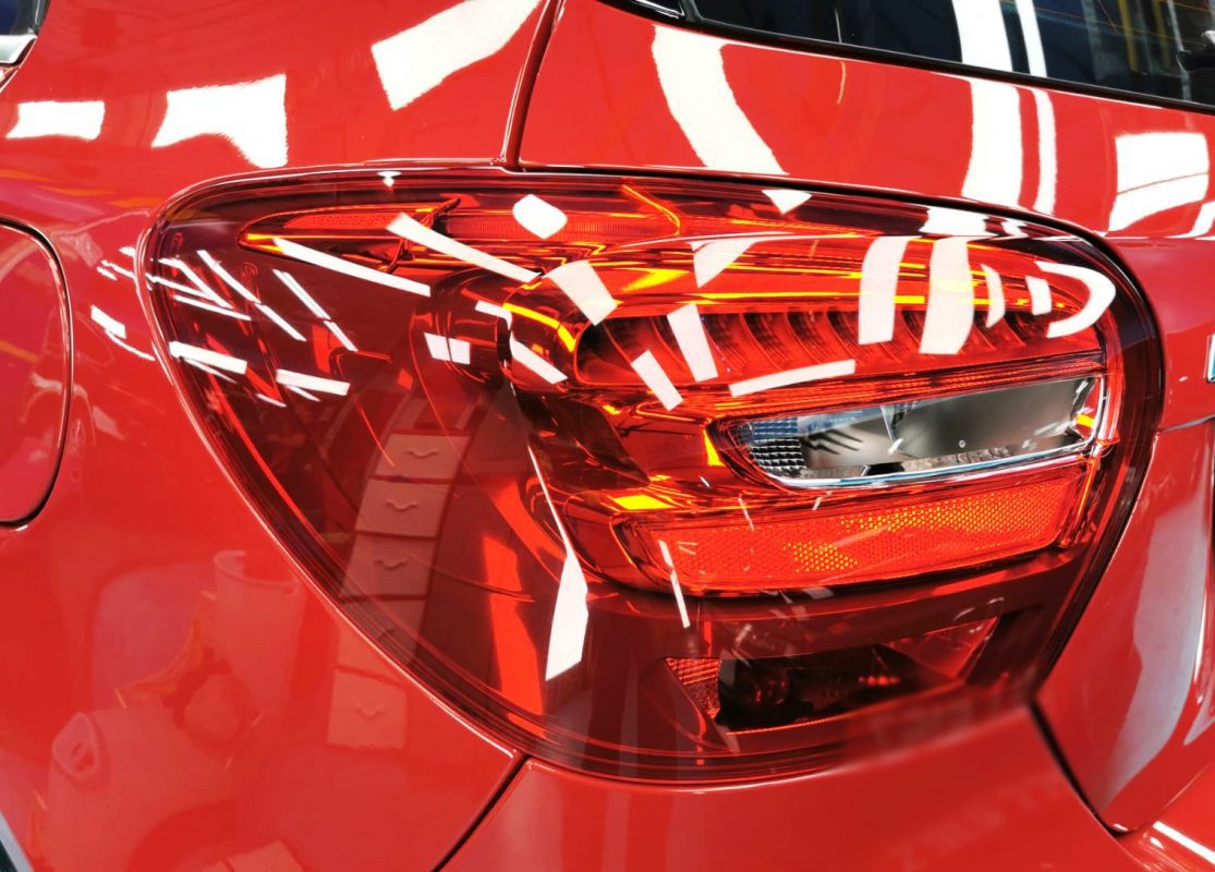 The coated bonnet of the A180 under workshop lighting.