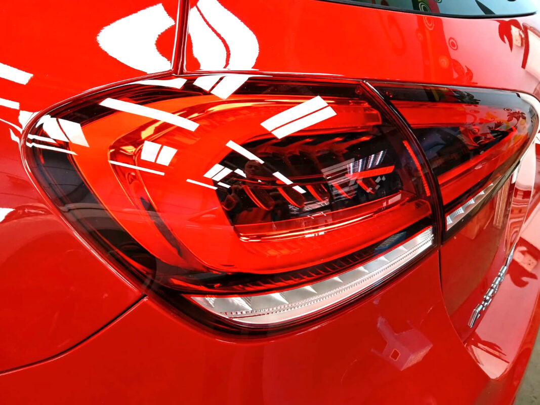 The coated bonnet of the Mercedes-Benz A200 under workshop lighting.