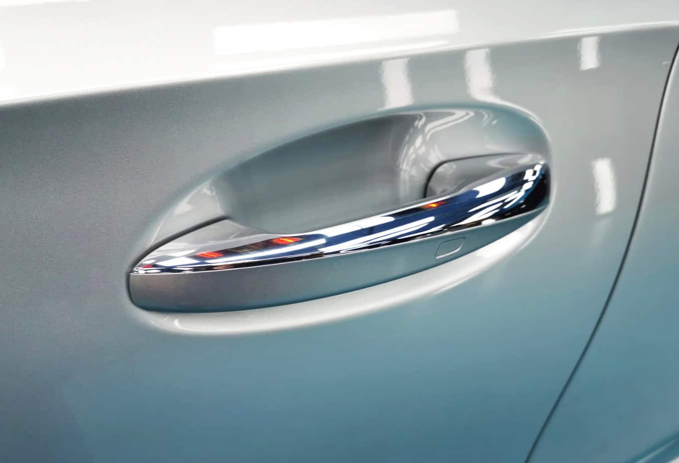 The coated bonnet of the Mercedes-Benz A200 under workshop lighting.
