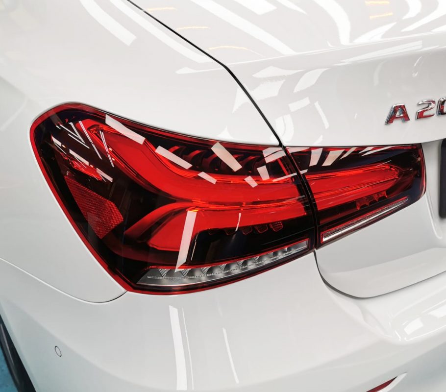 The coated bonnet of the Mercedes-Benz A200 under workshop lighting.