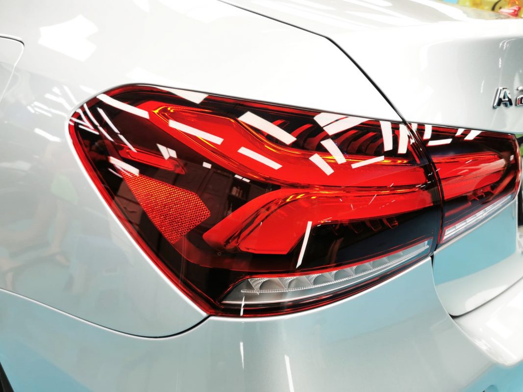The coated bonnet of the Mercedes-Benz A200 under workshop lighting.