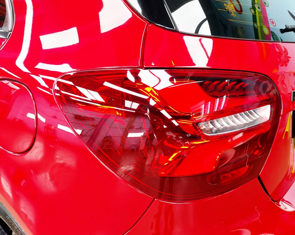 The coated bonnet of the Mercedes-Benz A250 Sport under workshop lighting.