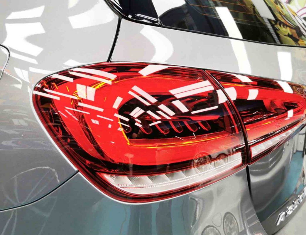 The coated bonnet of the Mercedes-Benz A250 under workshop lighting.