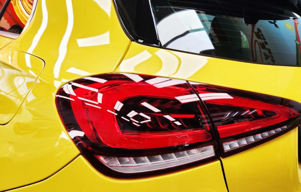 The coated bonnet of the Mercedes-Benz AMG A35 under workshop lighting.