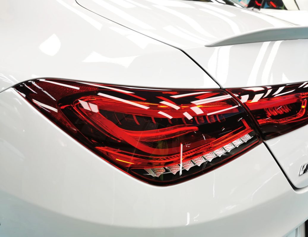 The coated bonnet of the Mercedes-Benz AMG CLA35 under workshop lighting.
