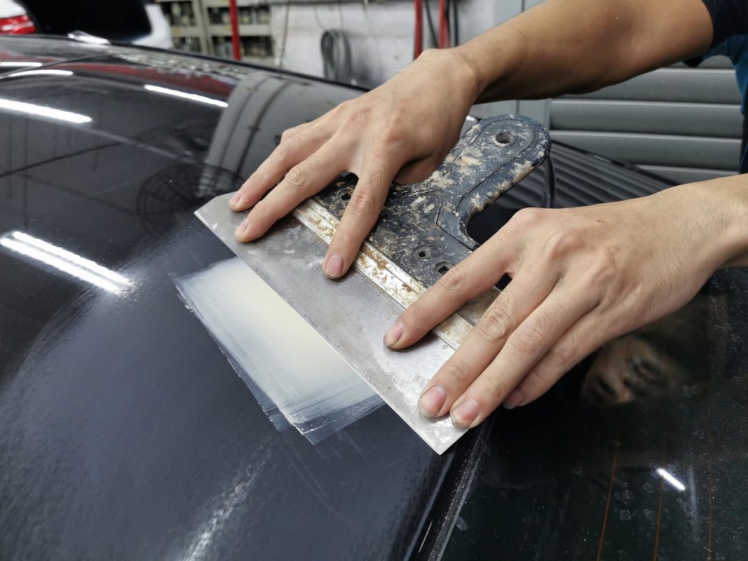 The AMG E53's body being checked and patched for paintwork imperfections.