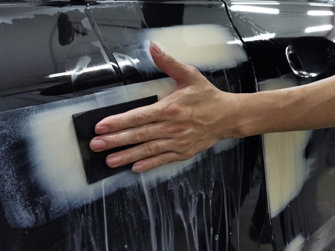 Wet-sanding the AMG E53's panels to smooth the existing paintwork.