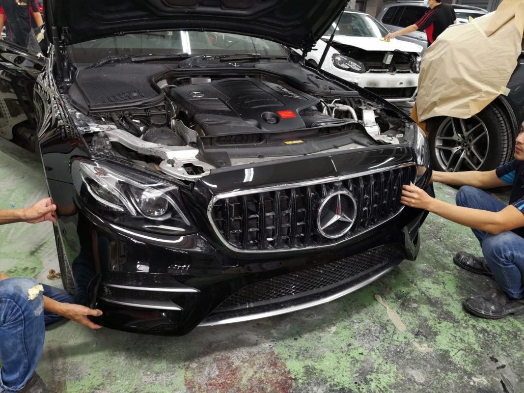 The AMG E53 being wet-sanded again after spraying for an even surface.