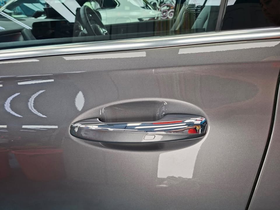 Close-up of the grey door panel and chrome door handle.