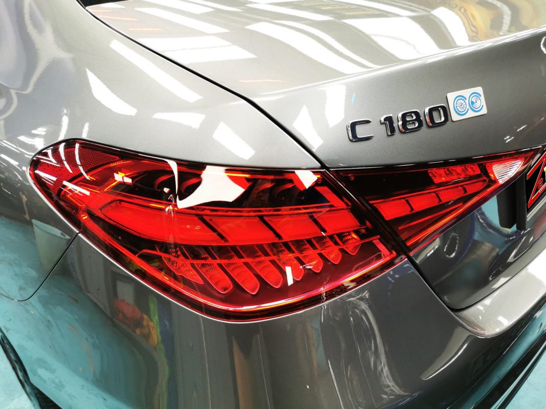 The coated bonnet of the C180 under workshop lighting.
