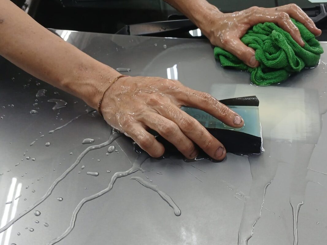 Wet-sanding a panel on the C180 to bring the surface smooth and level.
