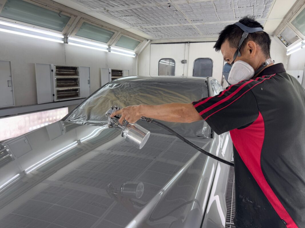 The C180 in the spray booth, fresh paint being applied.