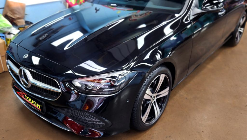 The Mercedes-Benz C180 from a side angle after the ceramic coating.