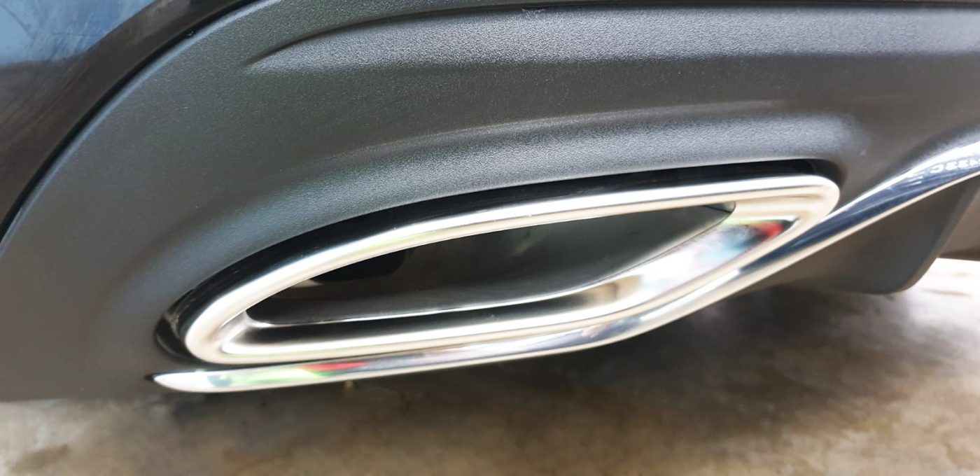 The coated bonnet of the Mercedes-Benz C200 AMG under workshop lighting.