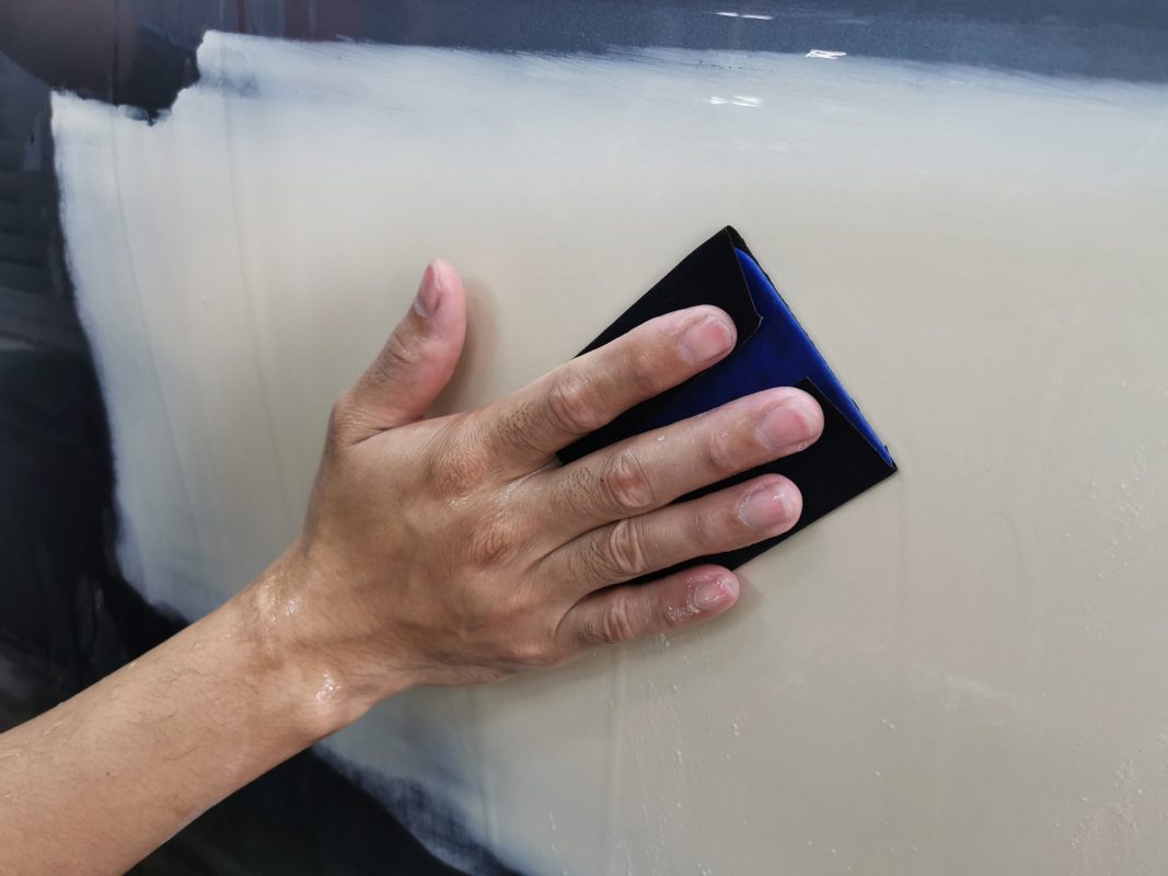 Continuing to wet-sand the body in preparation for spraying.
