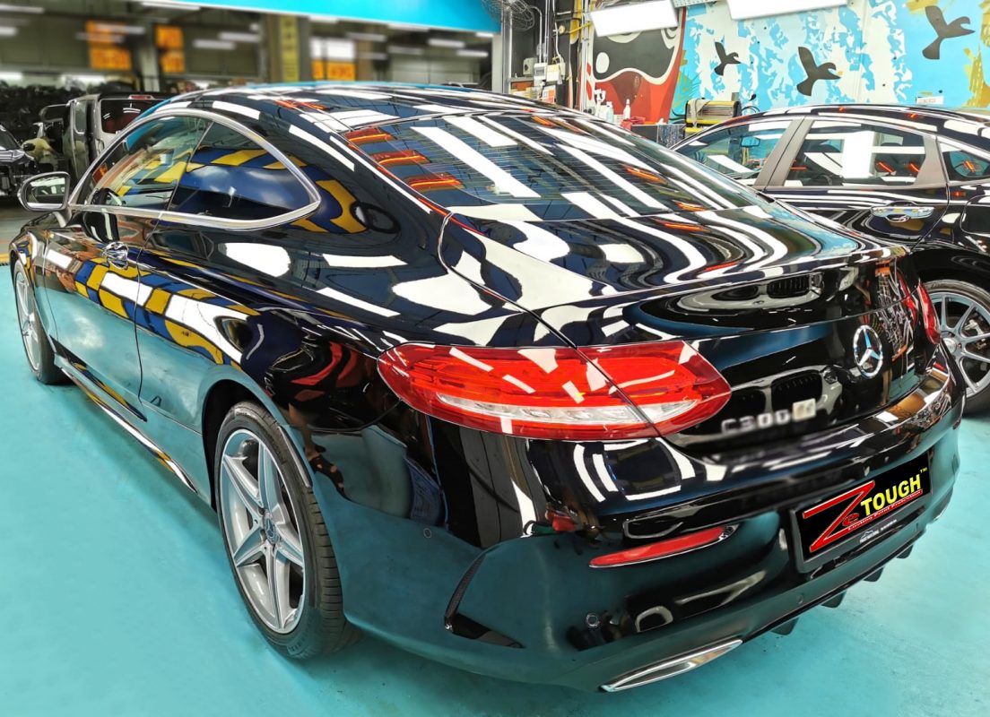 Rear quarter of the black Mercedes-Benz C300, glossy and protected.