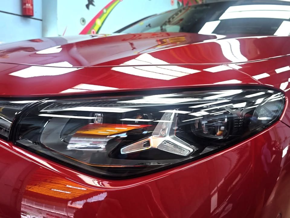 Close-up of the CLA headlamp with star-shaped light elements beside the red wing.