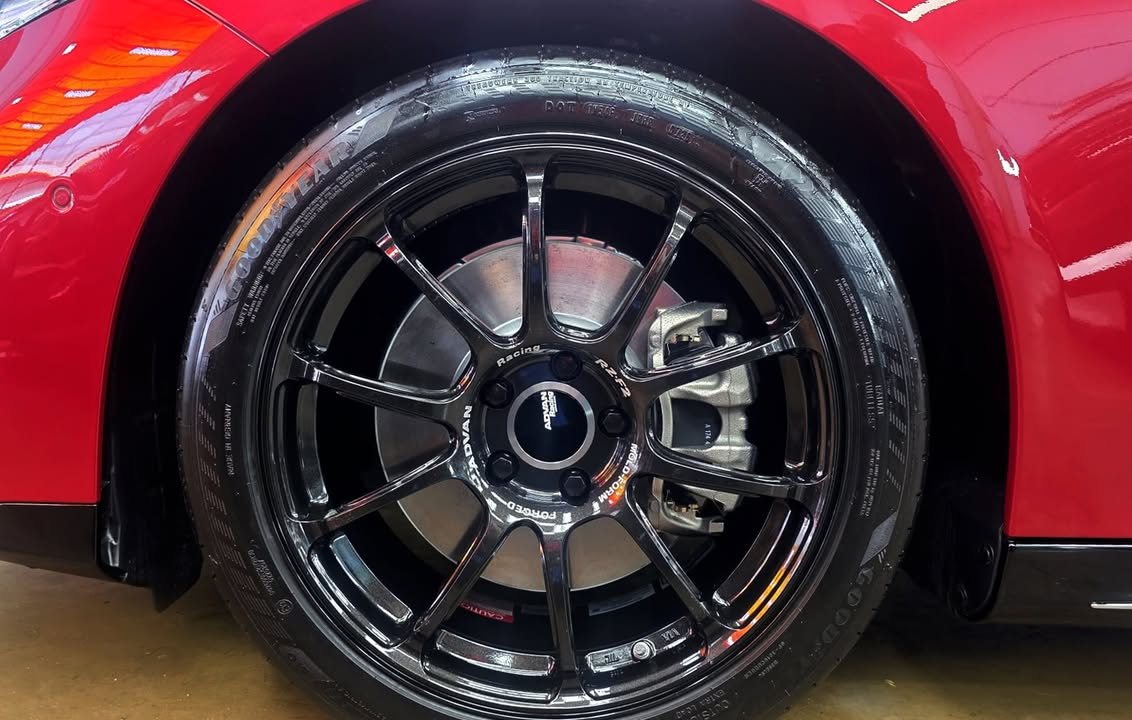 Close-up of the black multi-spoke alloy wheel.