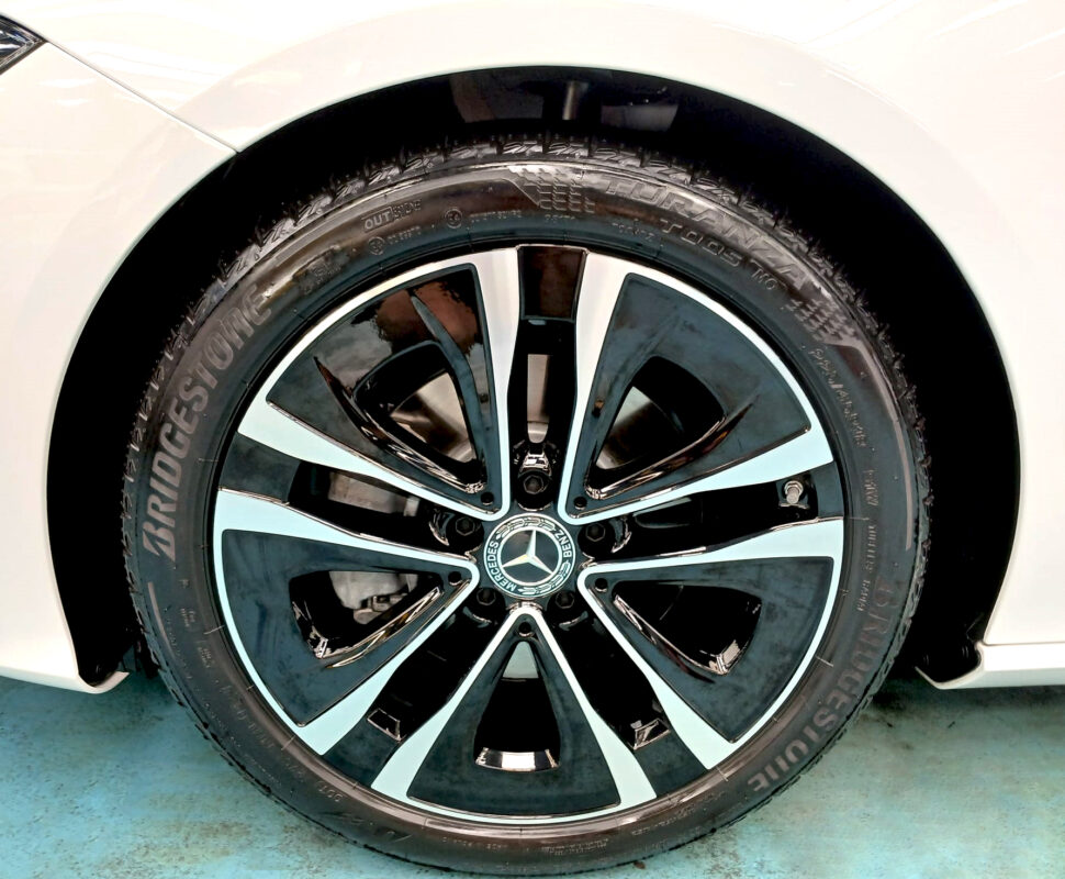 The coated bonnet of the Mercedes-Benz CLA180 under workshop lighting.