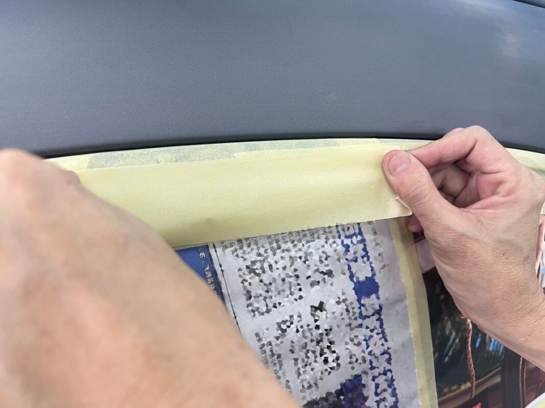A Revol Carz painter laying the new coat onto the CLA180.