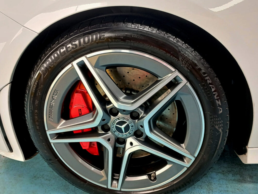 The coated bonnet of the Mercedes-Benz CLA180 under workshop lighting.