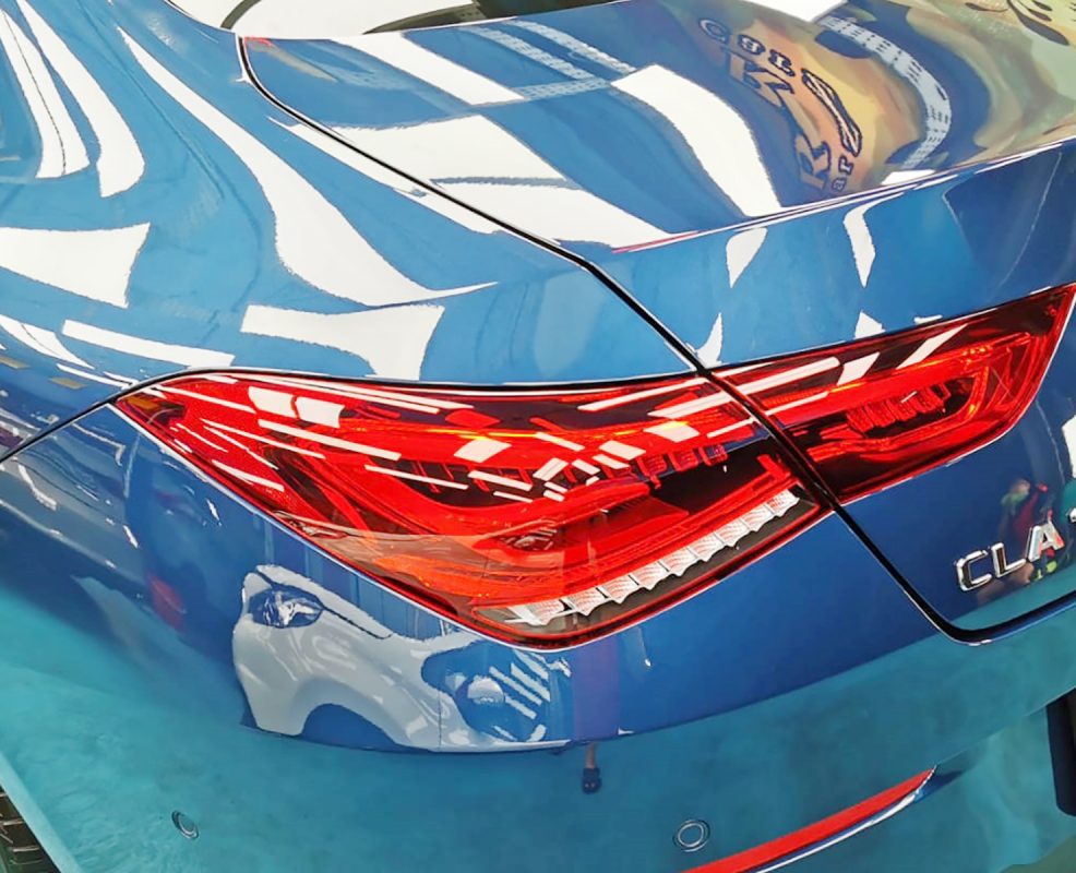 The coated bonnet of the Mercedes-Benz CLA180 under workshop lighting.