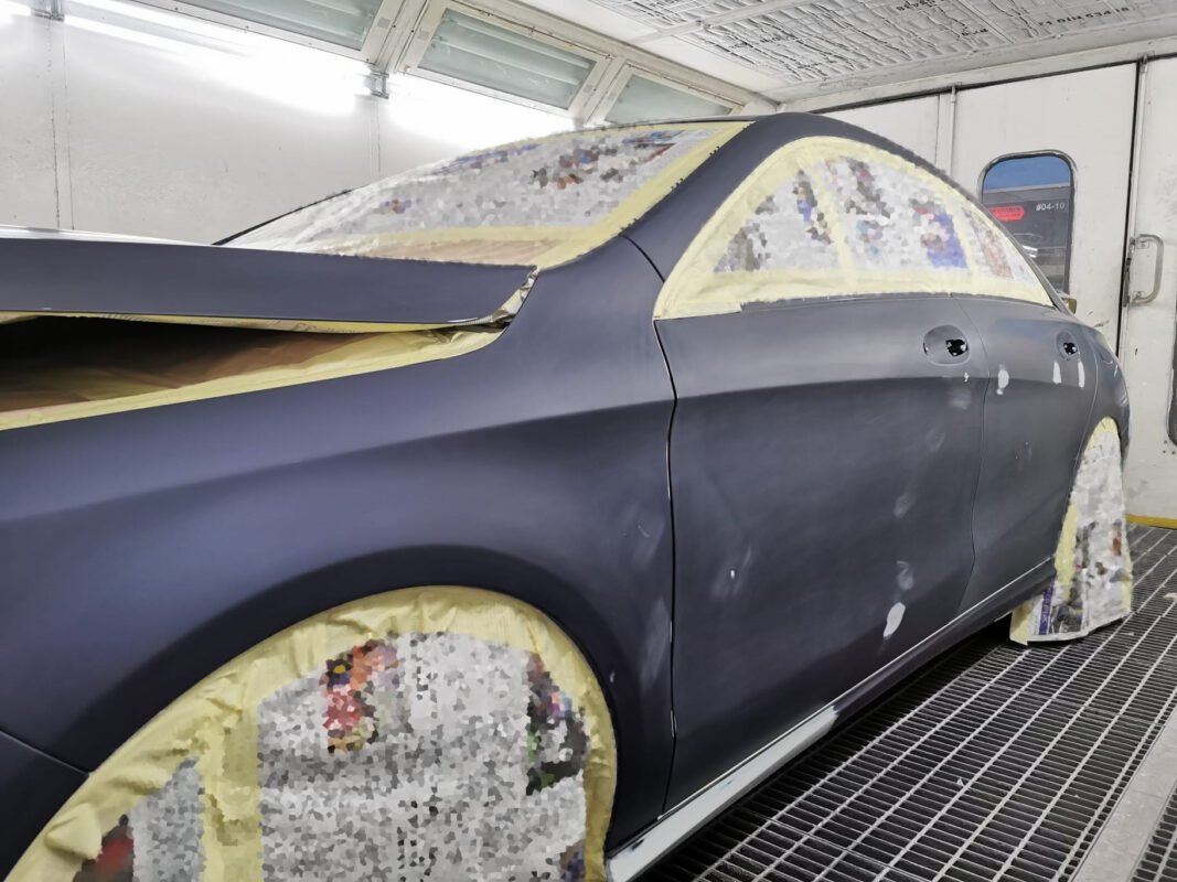 Masking the Mercedes-Benz CLA200 before entering the spray booth.