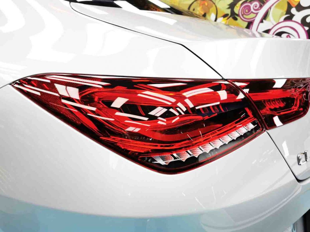 The coated bonnet of the CLA under workshop lighting.