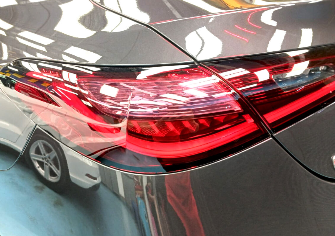 The coated bonnet of the Mercedes-Benz CLE180 under workshop lighting.