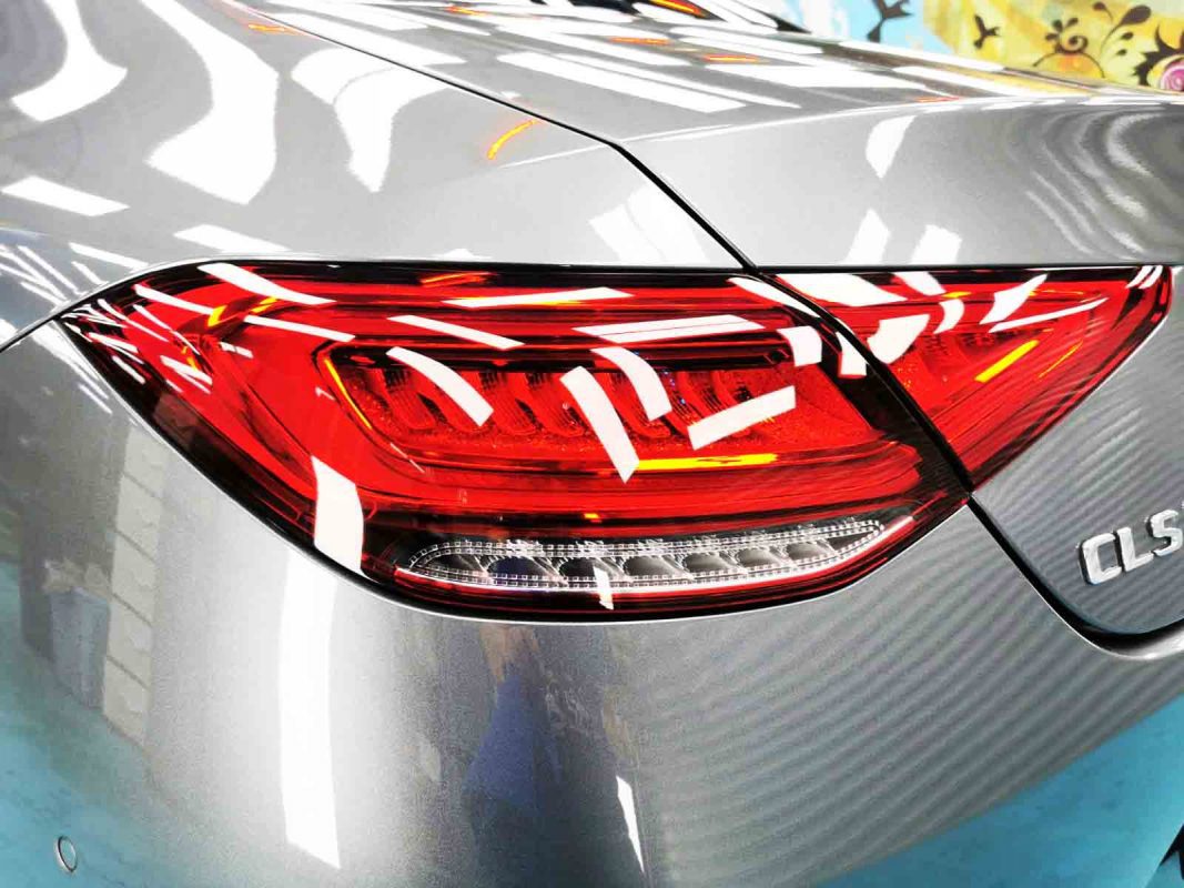 The coated bonnet of the CLS 350 under workshop lighting.