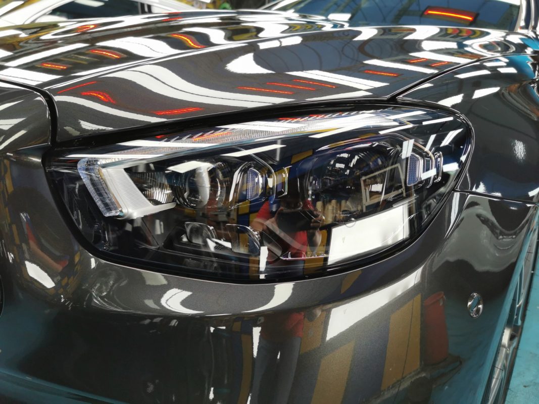 The E200 AMG's coated paintwork showing clean reflections.