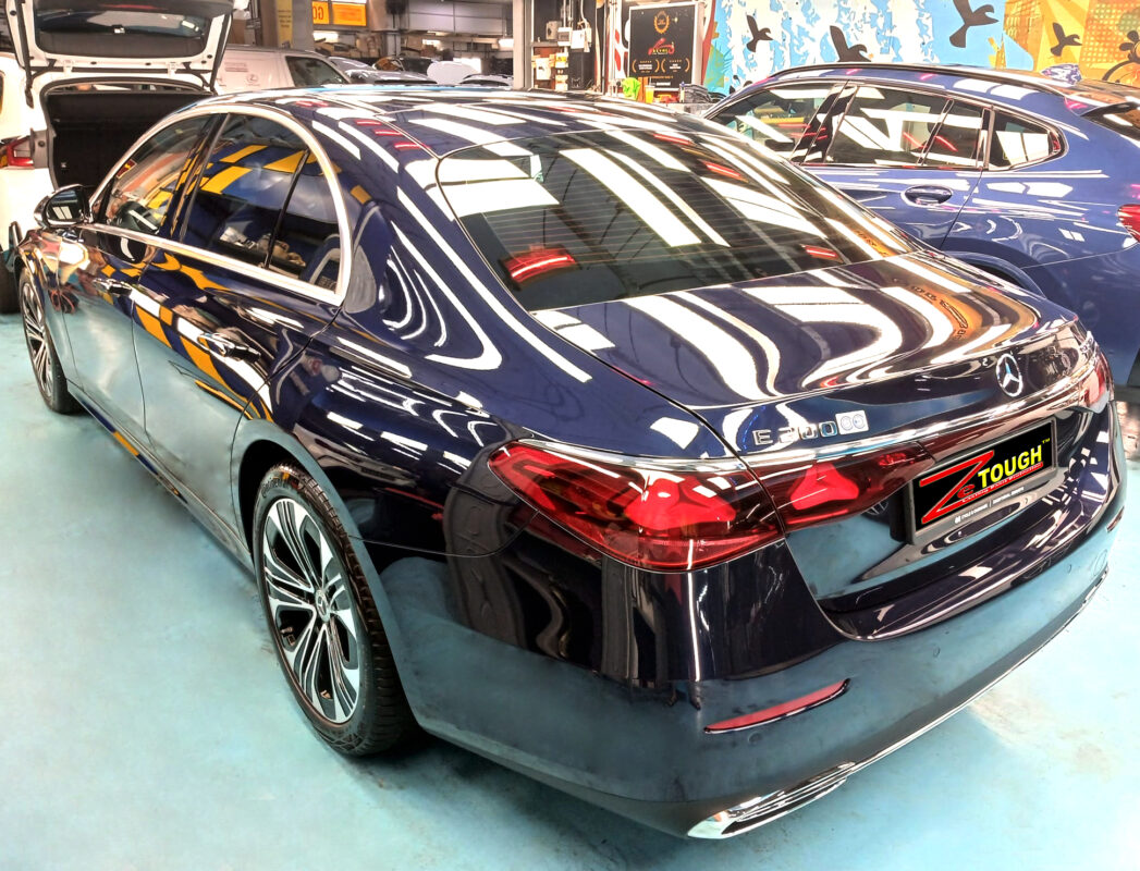 The Mercedes-Benz E200 parked in the workshop, freshly coated.